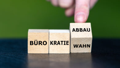 Symbol for bureaucracy reduction in Germany. Wooden cubes form the expression 'Buerokratiowahn' (bureaucracy delusion) and 'Buerokratie Abbau' (bureaucracy reduction).