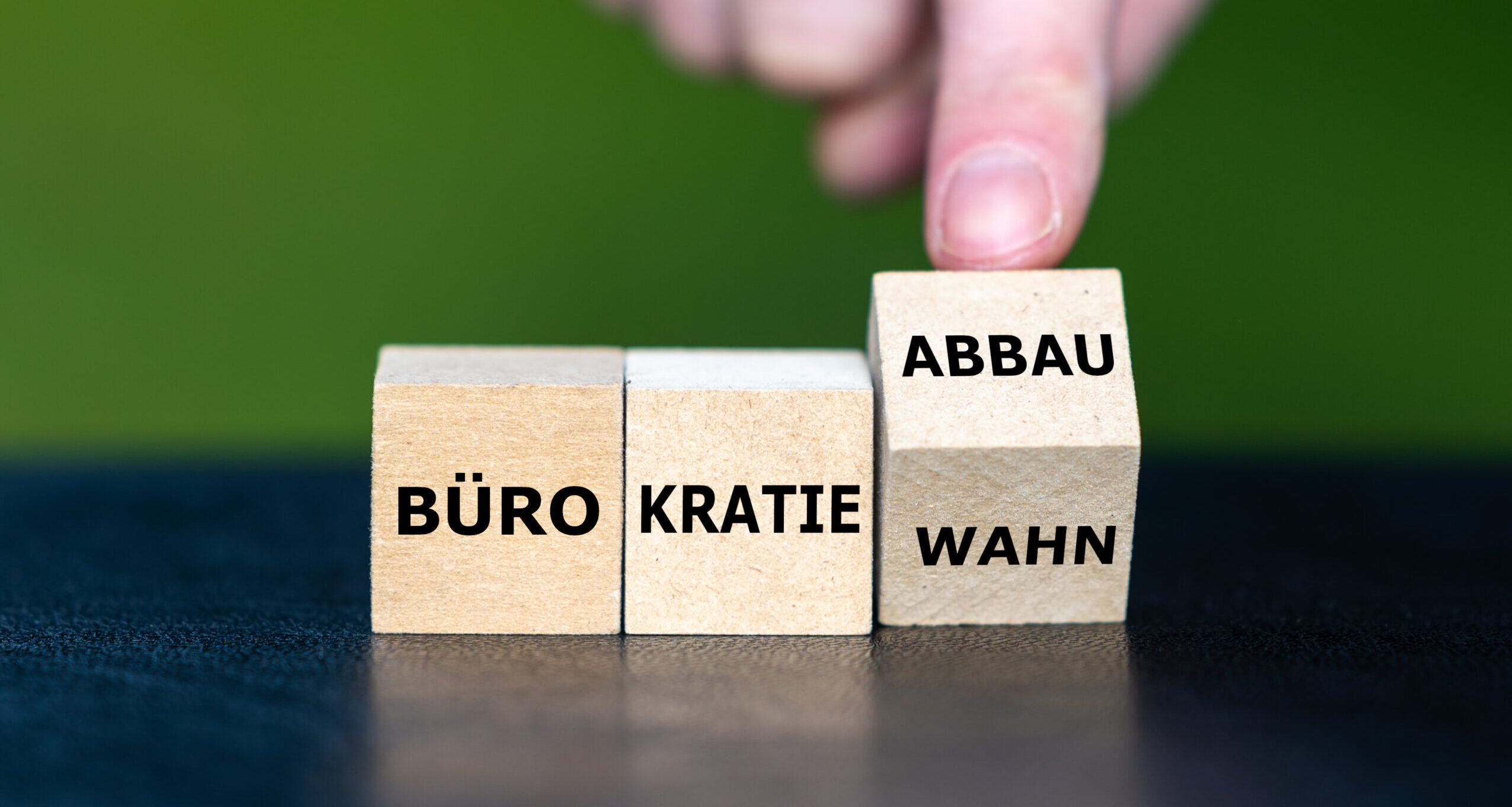 Symbol for bureaucracy reduction in Germany. Wooden cubes form the expression 'Buerokratiowahn' (bureaucracy delusion) and 'Buerokratie Abbau' (bureaucracy reduction).